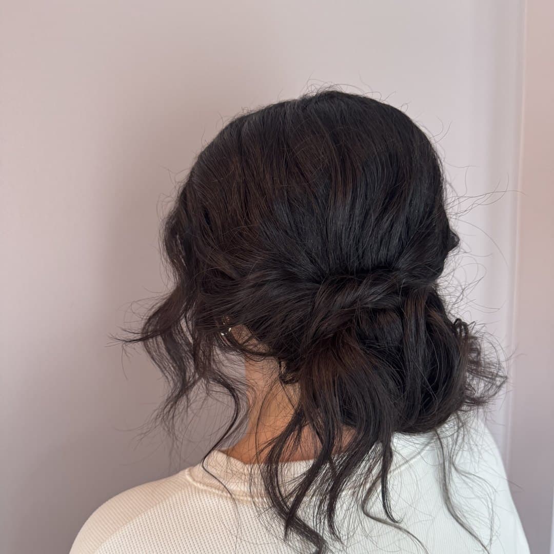 Soft low bun with face-framing pieces